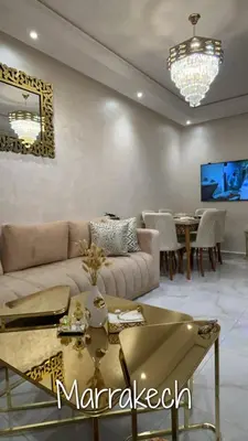 a living room with a couch and a table at Appartement Cosy Marrakech in Marrakech