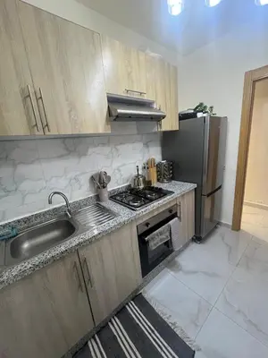 a kitchen with a sink and a refrigerator at Appartement Cosy Marrakech in Marrakech
