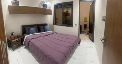 a bedroom with a large purple bed in a room at Marrakech duplex apartment in Marrakech