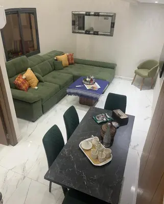 a living room with a green couch and a table at Marrakech duplex apartment in Marrakech