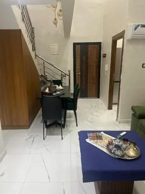 a living room with a table and a dining room at Marrakech duplex apartment in Marrakech