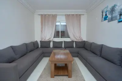 a living room with a couch and a coffee table at appartement majorelle in Marrakech