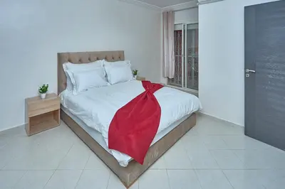 a bedroom with a bed with a red blanket on it at appartement majorelle in Marrakech