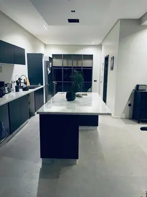 a large kitchen with a potted plant on a counter at Magnifique villa privée piscine 3ch, centre in Marrakech