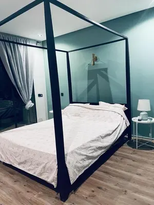 a bedroom with a canopy bed with a cross on it at Magnifique villa privée piscine 3ch, centre in Marrakech