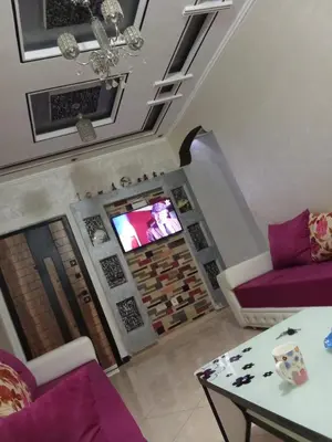 a living room with a couch and a tv at Basatine gelez in Marrakech