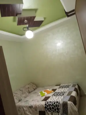 a small bedroom with a bed with a quilt on it at Basatine gelez in Marrakech
