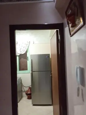 a kitchen with a stainless steel refrigerator in a room at Basatine gelez in Marrakech