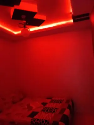 a red room with a bed and a red light at Basatine gelez in Marrakech