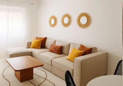 a living room with a couch and mirrors on the wall at Appart Majorelle in Marrakech
