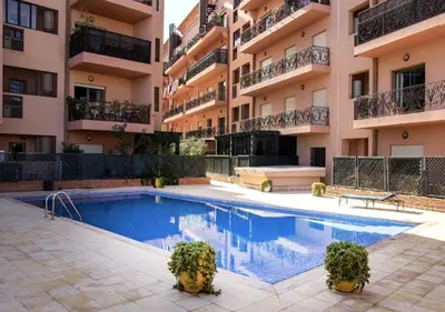 a swimming pool in front of a building at Appart Majorelle in Marrakech