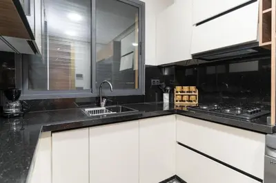 a kitchen with white cabinets and a sink at Comfort & Elegance Marrakech in Marrakech
