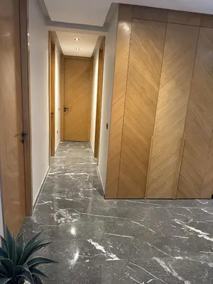 a hallway with marble floors and wooden cabinets at Comfort & Elegance Marrakech in Marrakech