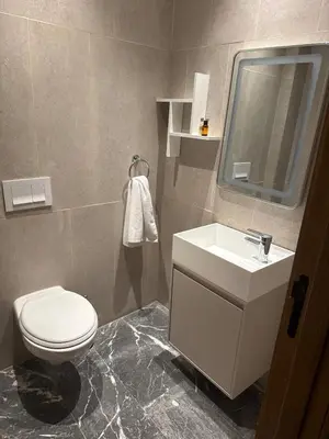 a bathroom with a toilet and a sink and a mirror at Comfort & Elegance Marrakech in Marrakech