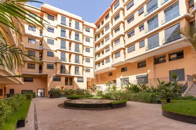 an apartment building with a courtyard with a fountain at Comfort & Elegance Marrakech in Marrakech