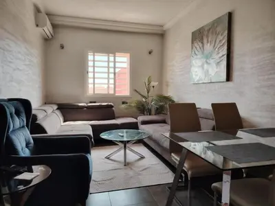 a living room with a couch and a table at Apartment heart of Marrakech in Marrakech