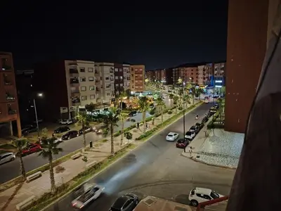 a city street at night with cars parked on the street at Apartment heart of Marrakech in Marrakech