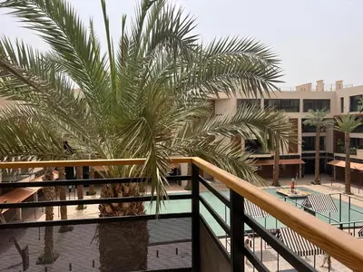 a palm tree on the balcony of a building at M Résidence Marrakech Luxury Serviced Apartments in Marrakech