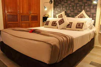 a bedroom with a large bed with white sheets and pillows at VERY RARE APARTMENT GUELIZ CENTER OF Marrakech in Marrakech