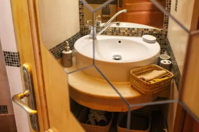 a small bathroom with a sink and a mirror at VERY RARE APARTMENT GUELIZ CENTER OF Marrakech in Marrakech