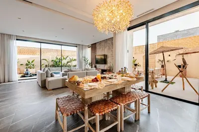 a living room with a table with food on it at Large Private Pool, Breakfast Included, Near Golf in El Rhechat
