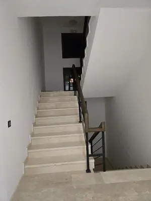 a staircase with a wooden railing and a stair case at Cozy Family Apartment 2BR Pool Parking Gueliz Marrakesh in Marrakech
