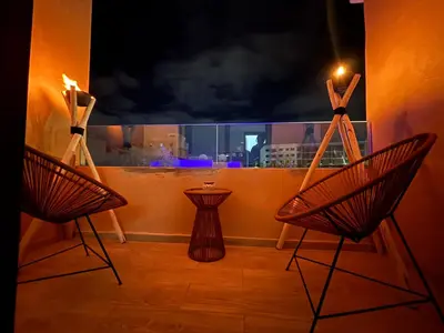 two chairs in a room with a view of a city at Cozy Family Apartment 2BR Pool Parking Gueliz Marrakesh in Marrakech
