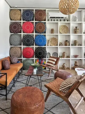 a room with chairs and tables and a wall with plates at Dariana guesthouse in Marrakech