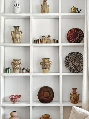 a white shelf with vases and plates on it at Dariana guesthouse in Marrakech