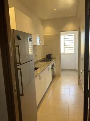 a kitchen with a refrigerator and a tile floor at pleasant stay in Marrakesh in Marrakech