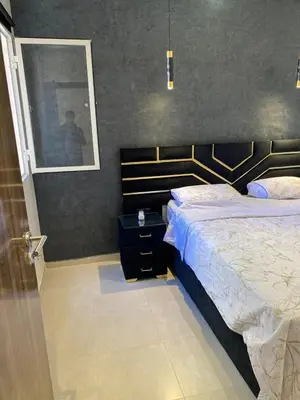 a bedroom with a bed and a picture on the wall at pleasant stay in Marrakesh in Marrakech