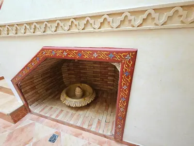 a room with a fireplace with a person in it at Riad zahra in Marrakech