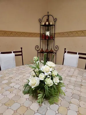 a vase of white flowers on a table at Riad zahra in Marrakech