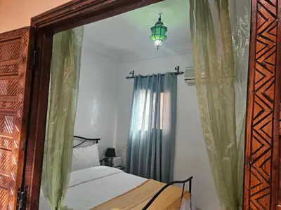 a bedroom with a bed and a large mirror at Riad zahra in Marrakech