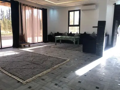 a living room with a couch and a table at Dar AZZARO in El Rhechat