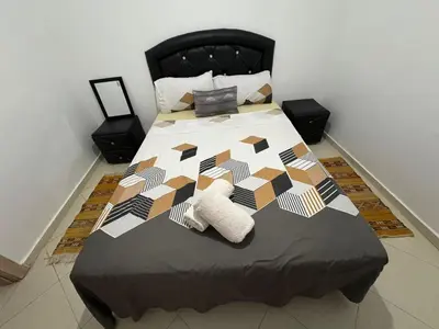 a bedroom with a large bed with a black headboard at Gueliz modern in Marrakech