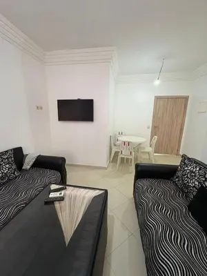 a living room with two couches and a tv at Gueliz modern in Marrakech