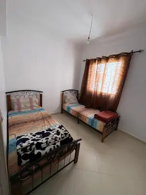 a bedroom with a cow bed and a window at Gueliz modern in Marrakech