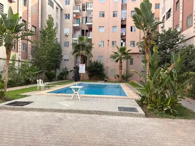 a swimming pool in front of a building at Gueliz modern in Marrakech