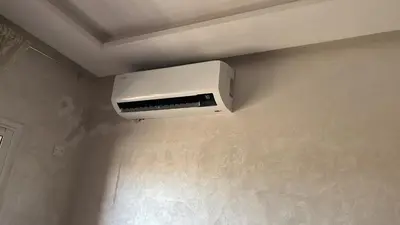 a white air conditioner on a wall in a room at Apparemment à Marrakech in Marrakech