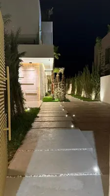 a driveway leading to a house at night at Villa Talya in Marrakech