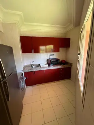 a kitchen with red cabinets and a sink at Atlas feeling in Marrakech