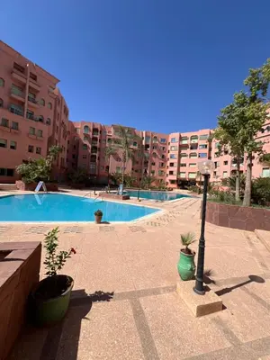 a swimming pool with a light pole and some buildings at Atlas feeling in Marrakech
