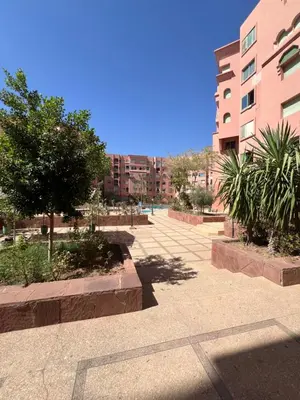 a courtyard with trees and buildings in a city at Atlas feeling in Marrakech