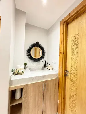a bathroom with a sink and a mirror at Le cœur de la ville ocre in Marrakech