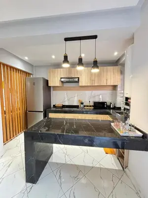 a kitchen with a black counter top in a room at Le cœur de la ville ocre in Marrakech