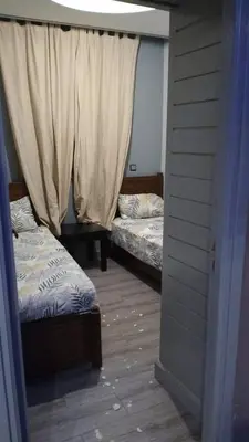 a room with two beds and a window at Bssatin gueliz in Marrakech