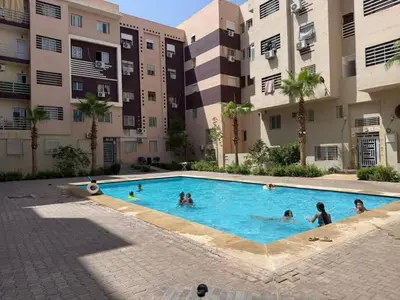 a group of people in a swimming pool in a building at Bssatin gueliz in Marrakech