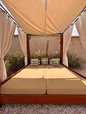 a bed in a tent with curtains at Villa Cactus & chill - Breakfast included! in Marrakech