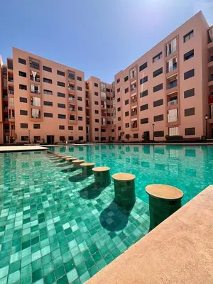 a swimming pool with a row ofools in front of buildings at NEW Marrakech Pool Center - ONLY FAMILY in Marrakech